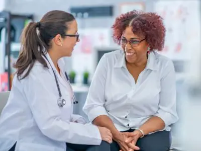 A medical practitioner in conversation with a patient