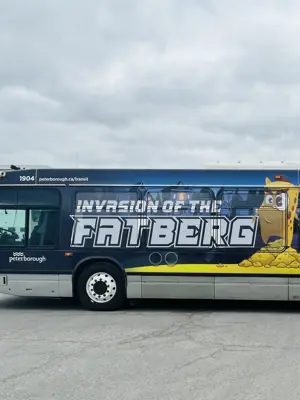 Photo of a City bus with a "Fatberg" waste management advertising wrap on it.