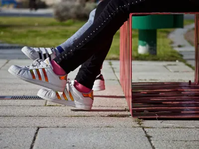 Teenagers sitting on a bench outdoors in the sun